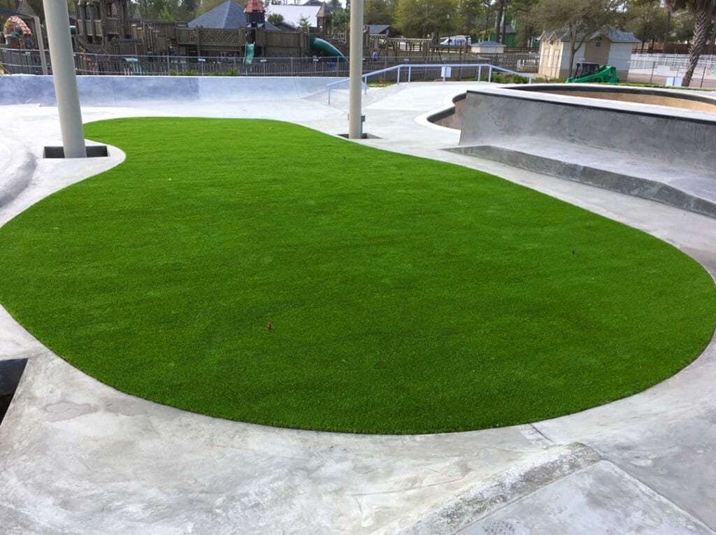 green turf area inside skate park tricks area