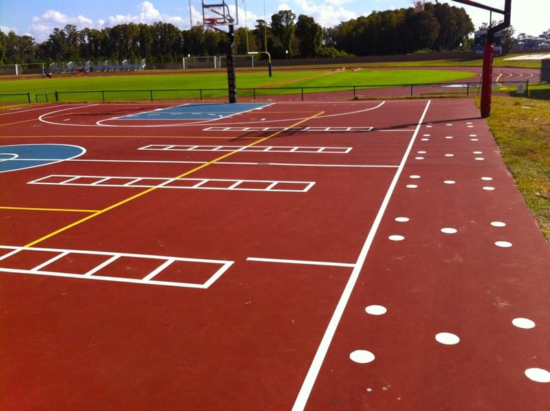 image of the outdoor basketball court, red court with white and yellow stripes