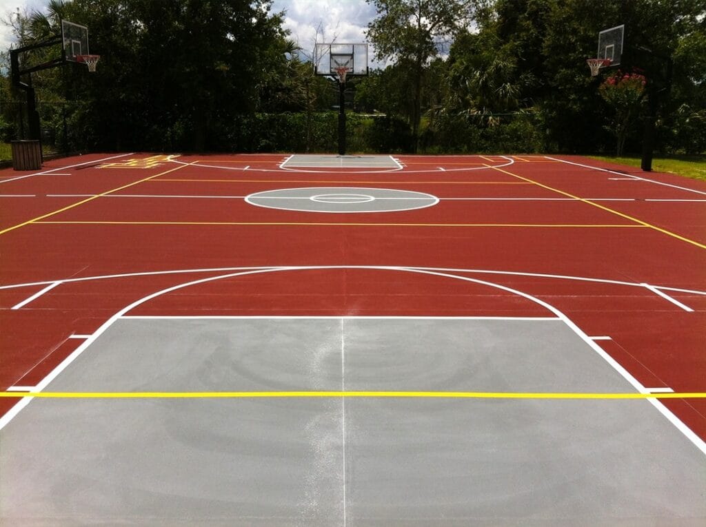 image of the outdoor basketball court, red court with white and yellow stripes