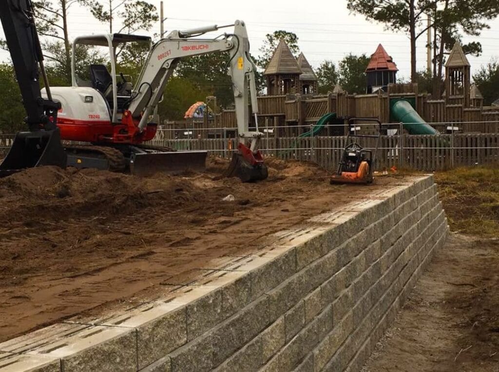 image of large construction equipment moving dirt on site for shade installation at skate park