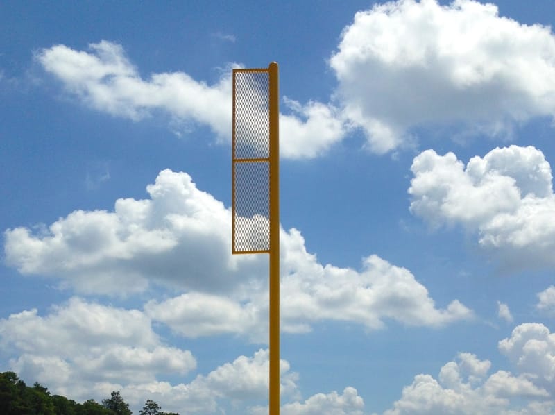 image of tall yellow pole on sports field