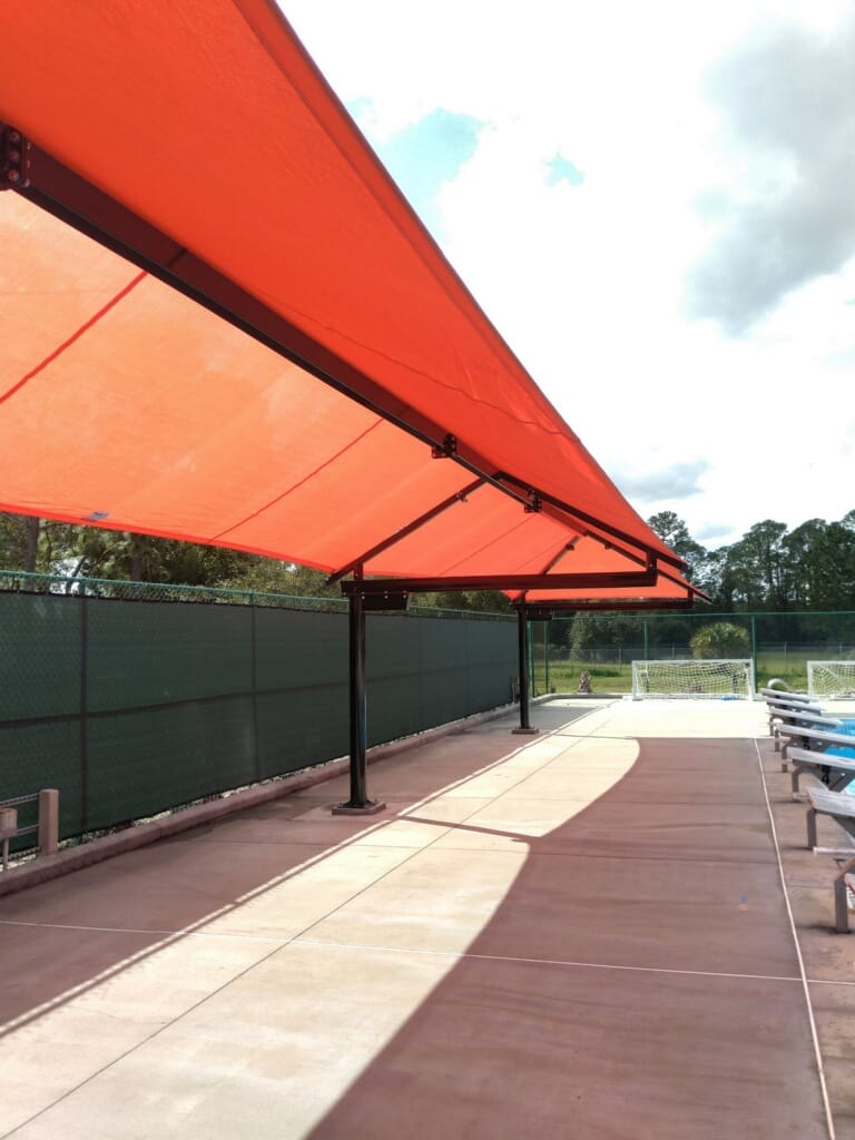 image of red shades extending length of pool deck
