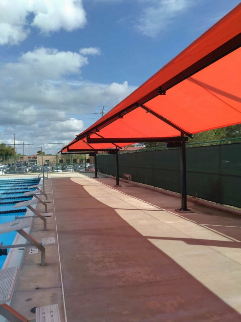 image of red shades extending length of pool deck