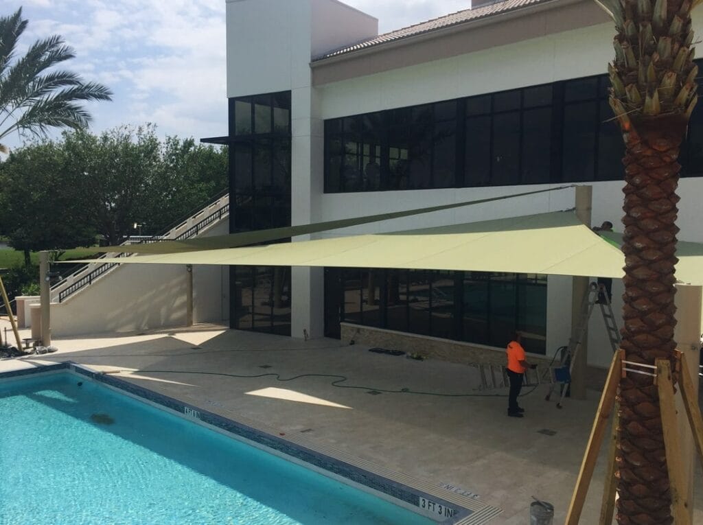 image of shade structure installation above pool deck
