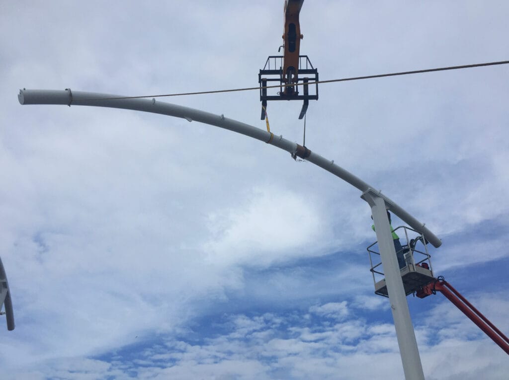 image of crane installing parts of shade structure posts