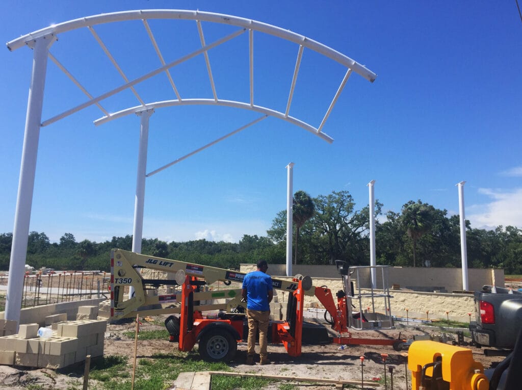image of men working on shade structure installation