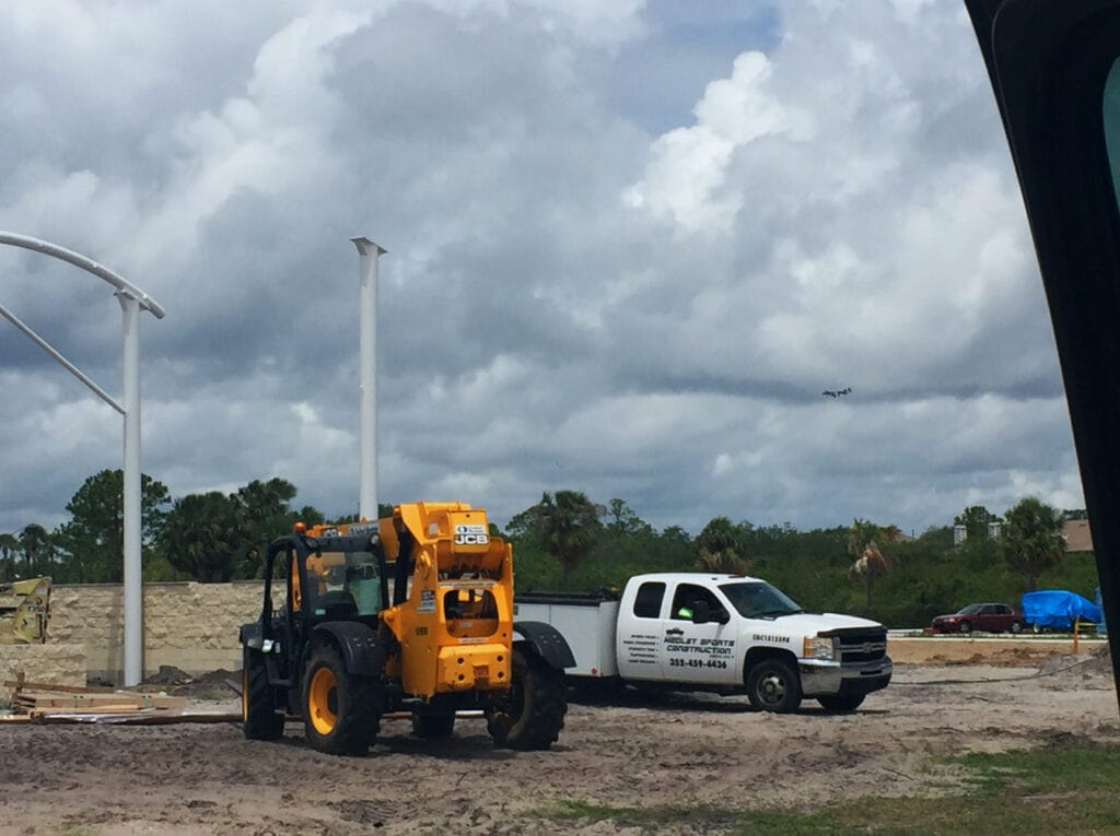 image of two work trucks on site of shade structure installation