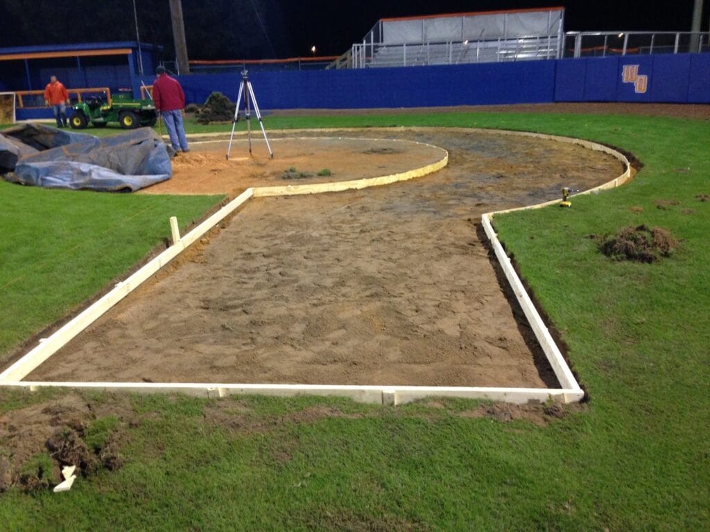 layout in ground, built of wood, for turf halo in field, night time