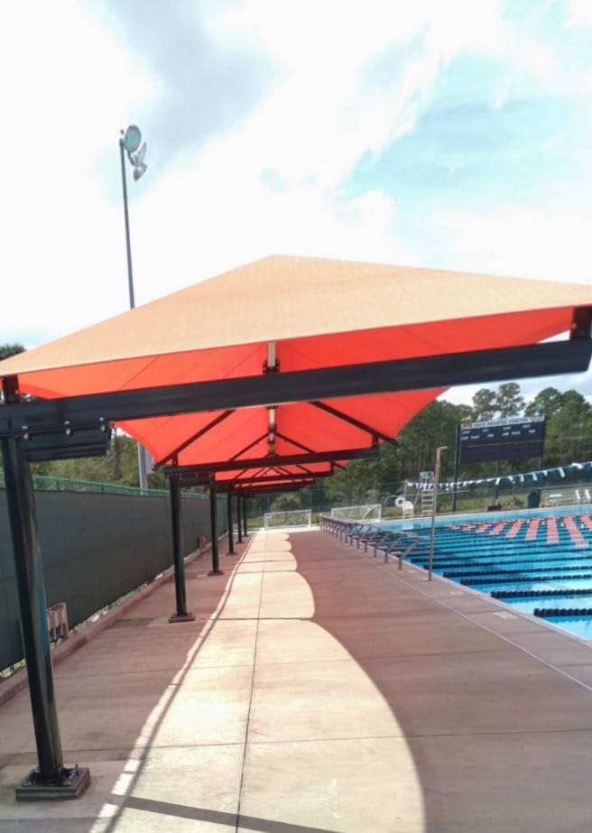 image of red shades extending length of pool deck