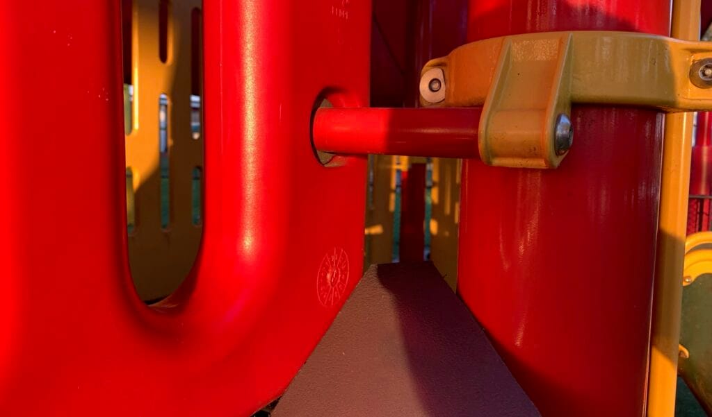 closeup image of a large bolt on playground equipment